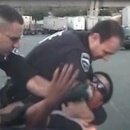 Photo: Cops hold man down and sic K-9 on him after beating him - for dancing in a parking lot